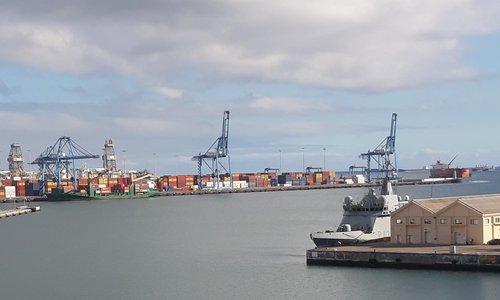 The port of Las Palmas, Gran Canaria. A nearby ship is docked and shipping containers can be seen in the distance.